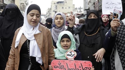 Jordanian women take part in a demonstration against French satirical weekly Charlie Hebdo for publishing a cartoon of the Muslim prophet Mohammed on January 16, 2015 in the capital Amman. Jordan’s King Abdullah II has characterised on January 15, 2015 as “irresponsible and reckless” this week’s latest issue of French satirical magazine Charlie Hebdo, saying its illustration of the Prophet Mohammed is an insult. Khalil Mazraawi / AFP photo