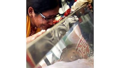 The wife of Hem Chandra Pandey weeps for her dead husband. Police say he was a Maoist, but his family says he was simply a freelance journalist interviewing the Maoist leader, Azad.