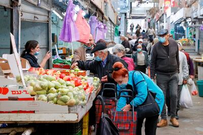 Israelis, wearing protective masks due to the Covid-19 pandemic, shop in the central market of Israel's coastal city of Netanya ahead of a third lockdown. AFP