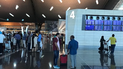 Passengers arrive at Hamad International Airport in Doha on June 12, 2017. Malak Harb / AP