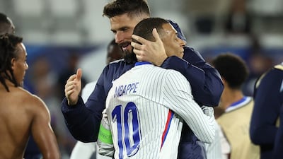 Olivier Giroud and Kylian Mbappe embrace at the end of the match between France and Canada. AFP