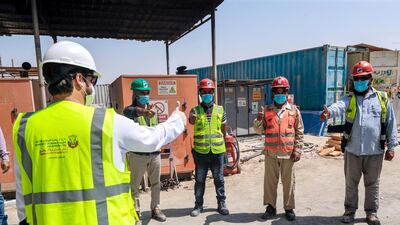 Workers on the construction site follow safety rules. Victor Besa / The National