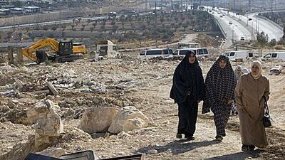Members of Palestinian family walk near the rubble of their house in November 2010, which was demolished by Jerusalem municipality workers because it was illegally built in occupied east Jerusalem.