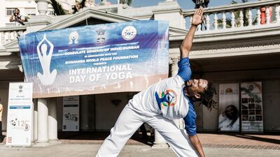 A yoga instructor takes part in a yoga session at North Beach in Durban, South Africa. Rajesh Jantilal / AFP