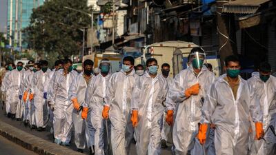 Indian police officers wearing protective gear patrol the streets of Mumbai amid the coronavirus lockdown. India's Aviation Ministry has asked airlines not to sell tickets until a final decision is made on the lockdown. EPA
