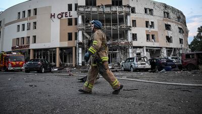 Firefighters work at the scene where a hotel was damaged by Russian missile fire in Zaporizhzhia. Reuters