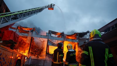 Firefighters work at the site of food warehouses hit by an Russian missile strike in Kyiv, Ukraine, on October 25, 2025. Reuters
