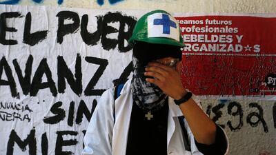 A protester rubs his eyes during the seventh day of protests. Getty Images