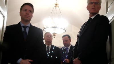US senator Lindsey Graham, second from left, listens as President Donald Trump speaks in the Diplomatic Room of the White House in Washington, on Sunday, October 27, 2019. AP Photo