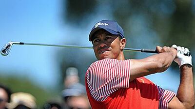 Tiger Woods, pictured today in a practice round for the US in the Presidents Cup in Australia, has confirmed his participation in the Abu Dhabi Golf Championship in January.