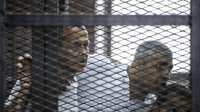 From left, Al Jazeera news channel's Australian journalist Peter Greste and his colleagues, Egyptian-Canadian Mohamed Fadel Fahmy and Egyptian Baher Mohamed, before the verdict from the Egyptian court that eventually handed them jail terms of between seven to 10 years on conviction of terrorism. Khaled Desouki/AFP Photo