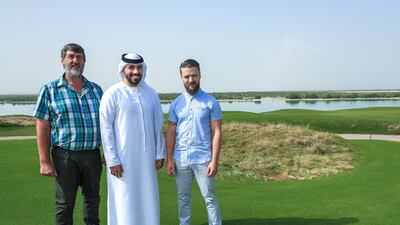 Frederik Langenhoven and his son Marius , right, with Omar Al Hosani, centre. Victor Besa / The National