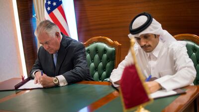 US secretary of state Rex Tillerson, left, and the Qatari minister of foreign affairs Sheikh Mohammed bin Abdulrahman Al Thani signing a memorandum of understanding in Doha, Qatar on July 11, 2017. Alexander W Riedel/US State Department via AP