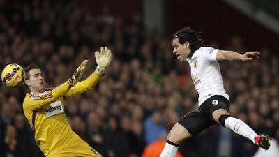Manchester United striker Radamel Falcao, right, misses a chance by shooting wide as West Ham United goalkeeper Adrian attempts to block the shot on Sunday during their Premier League match. Adrian Dennis / AFP