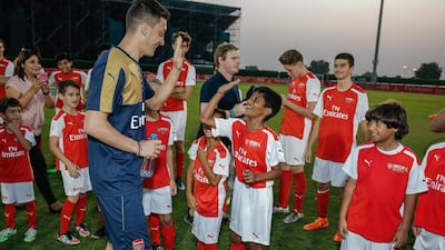 Mesut Ozil visits Arsenal Soccer School at The Sevens Stadium. High fives for his 8-9 year old fans. Victor Besa for The National