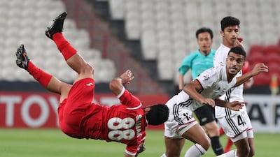 Al Jazira's Mohammad Al Musalami, right, and Siamak Nemati of Persepolis battle for the ball during their Asian Champions League game at Mohammed bin Zayaed Stadium in Abu Dhabi. Karim Sahib / AFP