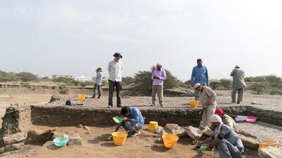 Archaeologist Silvio Reichmuth, left, at an ancient burial site that has been uncovered in Dibba. Reem Mohammed / The National