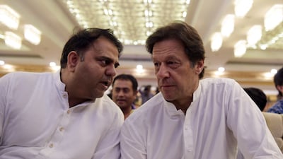 Imran Khan speaks with Fawad Chaudhry in Islamabad on July 9, 2018. AFP