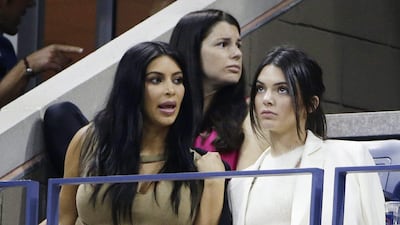 US television personalities Kim Kardashian, left, and Kendall Jenner shown in the stands during the US Open quarter-final match between Serena Williams and Venus Williams on Tuesday. Jason Szenes / EPA
