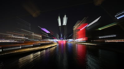 A slow exposure with zoom effect picture shows Dubai Canal illuminated. EPA