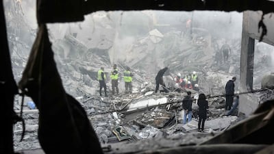 Rescuers sift through the rubble of a levelled building in Basta. AFP