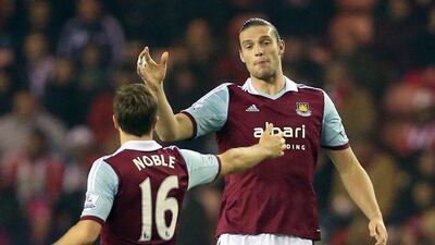 West Ham United striker ndy Carroll, right, celebrates after scoring the opening goal with midfielder Mark Noble during their Premier League victory over Sunderland on Monday night. Ian MacNicol / AFP / March 31, 2014