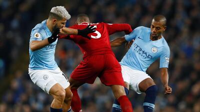 Manchester City's Sergio Aguero, left, and Fernandinho, right, in action with Liverpool's Georginio Wijnaldum. Reuters
