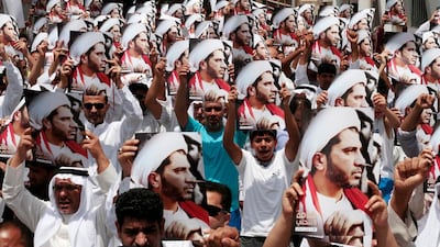 Bahraini anti-government protesters shout slogans and hold up images of Sheik Ali Salman, head of the Shiite majority's main political bloc, after midday prayers outside a mosque in Diraz, Bahrain, on Friday, June 29, 2012. Protesters gathered to denounce what they say was authorities attempt to kill Salman during last week's pro-democracy protests. Bahraini riot police fired tear gas, stun grenades and rubber bullets last Friday, injuring Salman and other opposition leaders who were on their way to lead an unauthorized march. (AP Photo/Hasan Jamali)