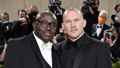 Edward Enninful, in white tie, and Alec Maxwell, in black tie, in tuxedos by Burberry. AP Photo