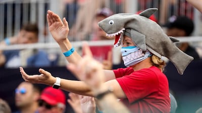 A fan wears a shark hat at a Washington Nationals baseball game in Washington. The Korean family behind the viral video 'Baby Shark' song are now worth about $125m. AP