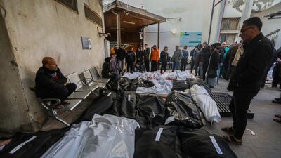 People mourn by the bodies of victims of an Israeli strike in Rafah. Getty Images
