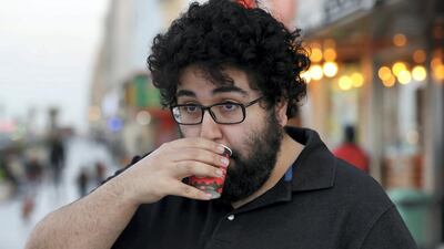 Abdulla Moaswes, the 'Karak Mufti', sips a cup of hot brew in Sharjah. Chris Whiteoak / The National