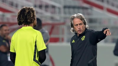 Jorge Jesus, right, speaks with Flamengo's Willian Arao during a training session in Doha. AP