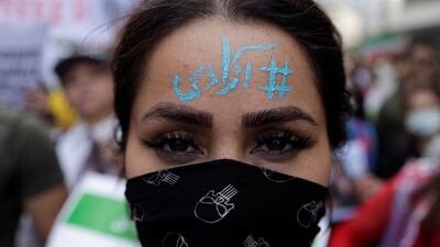 An Iranian woman living in Turkey with 'Freedom' written on her forehead takes part in a protest near the Iranian consulate in Istanbul. Reuters