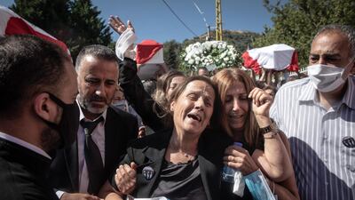 BEIRUT, LEBANON - AUGUST 17: Family members mourn as the coffins of firefighters Charbel Hetti, Najeeb Hetti and Charbel Karem who were killed in the August 4th, Beirut port explosion are carried to the church during their funeral service in their hometown of Qartaba on August 17, 2020 in Beirut, Lebanon. Najeeb Hetti, 27 his cousin Charbel Hetti, 22 and his sisters husband Charbel Karam, 37 were killed during the Beirut port explosion along with 7 other firefighters from the Karatina fire department, who were the first responders to the blaze. The remains of Najeeb and Charbel were found on August 13th, however the family refused to bury them until the body of Charbel Karam was found, his remains were recovered on August 15th. There has been little visible support from government agencies to help residents clear debris and help the displaced, although scores of volunteers from around Lebanon have descended on the city to help clean. (Photo by Chris McGrath/Getty Images)