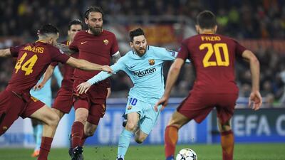 Barcelona forward Lionel Messi, centre, vies for the ball with Roma midfielder Daniele de Rossi, second from right, during their Uefa Champions League quarter-final second-leg match in Rome. Lluis Gene / AFP