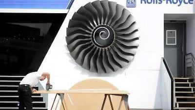 An employee works on the Rolls Royce stand at the Paris Air Show on Friday. Antoine Antoine for The National
