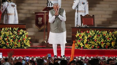 India's Prime Minister Narendra Modi gesturing towards supporters after his swearing-in ceremony at the presidential palace in New Delhi. Adnan Abidi / Reuters