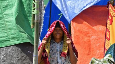 An Indonesian man arrives for Friday prayers on a field near temporary shelters in Pemenang, northern Lombok. AFP