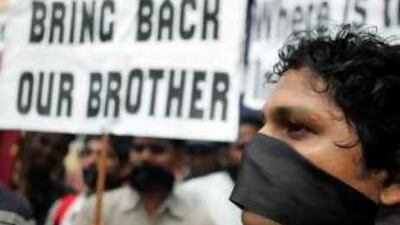 Family members and friends of Indian sailors holds placards during a silent protest in Mumbai.