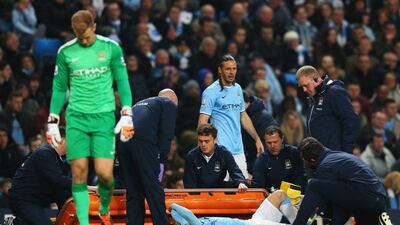 An injured David Silva of Manchester City is given treatment during his side's Premier League win over West Brom on Monday. He would leave the pitch with an ankle injury. Alex Livesey / Getty Images / April 21, 2014