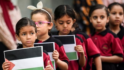 Pupils stand to mourn Palestinian children killed in Gaza, in Cairo, Egypt. Reuters