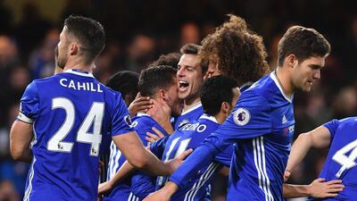 Eden Hazard celebrates with teammates after converting the penalty to earn Chelsea a 2-0 lead. Ben Stansall / AFP