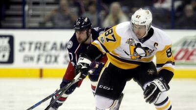 9. Pittsburgh Penguins forward Sidney Crosby, right, carries the puck against Columbus Blue Jackets forward Brandon Dubinsky during the first period of an NHL game in Columbus, Ohio. Paul Vernon / AP Photo