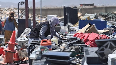 People look for useable items at a junkyard near the Bagram Air Base. AFP