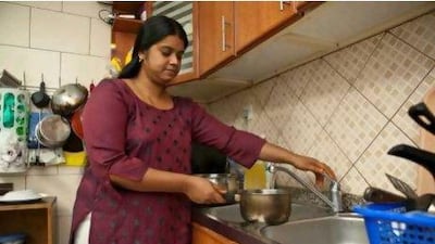 Susan Cherian fills a cooking pot with tap water at her apartment in Sharjah, but she does not use the tap water for cooking.