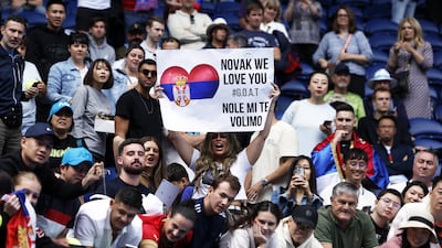 A spectator holds a placard during the match between Novak Djokovic and Adrian Mannarino. EPA