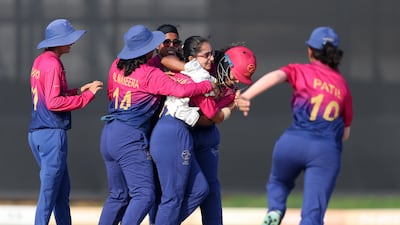 UAE bowler Mehak Thakur is mobbed by teammates after claiming the wicket of Nepal captain Puja Mahato.