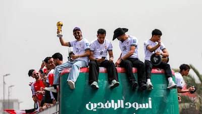 Iraqi players celebrate with fans in Baghdad after qualifying for the Fifa World Cup. AFP