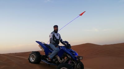 Adel Ali Hussain on his quadbike during a recent desert tour near Dubai. Courtesy: Mr Hussain